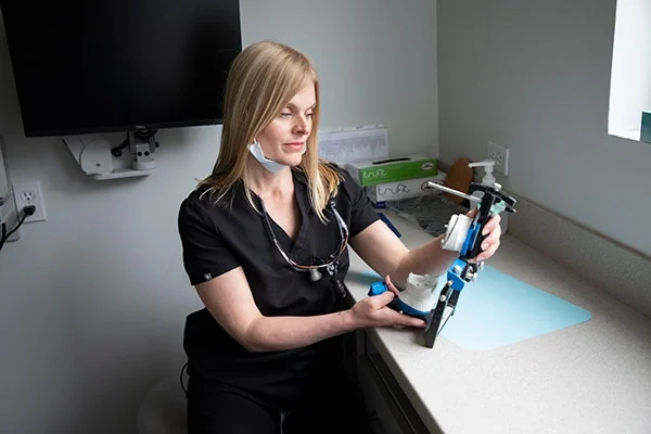 Dr. Suzanne Reinhardt examining a patient's models and prosthetic work.