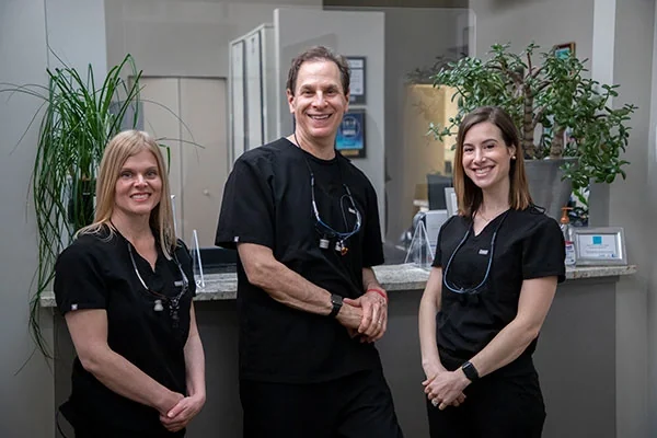 Dr. Suzanne Reinhardt, Dr. Steven Isaacson and Dr. Jacqueline Milone at the front desk.