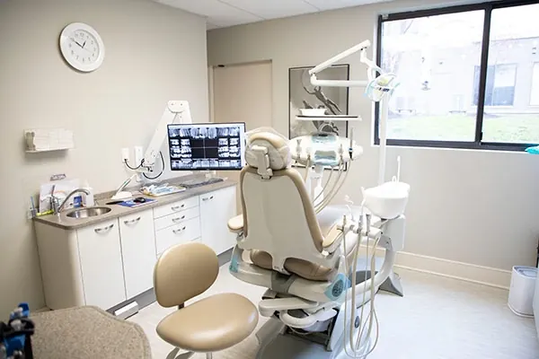 A bright treatment room at Prosthodontics of Princeton, with a window onto the trees.