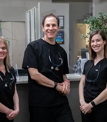 Dr. Reinhardt, Dr. Isaacson and Dr. Milone at the front desk.